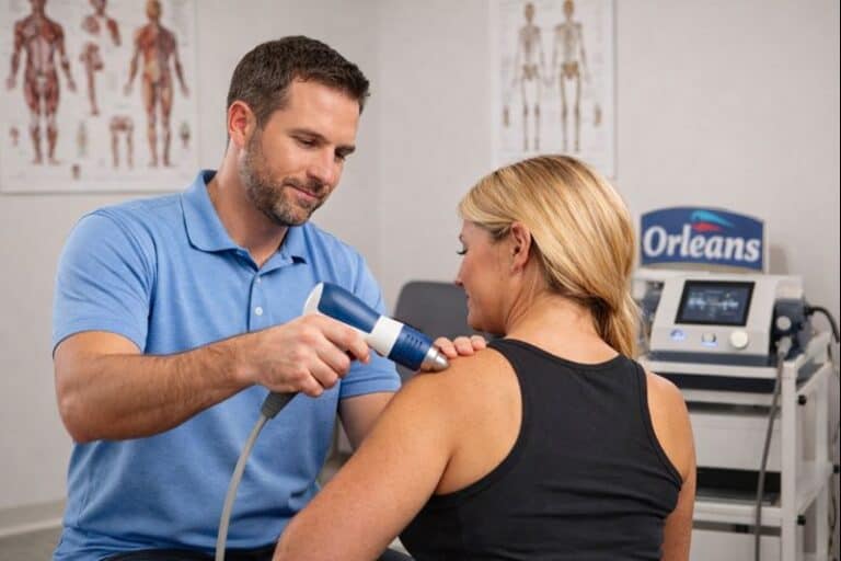 Physiotherapist performing shockwave therapy in Orleans clinic