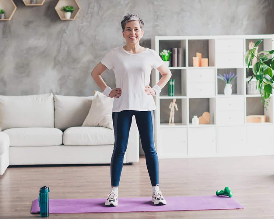 senior woman doing impact-free exercise at home