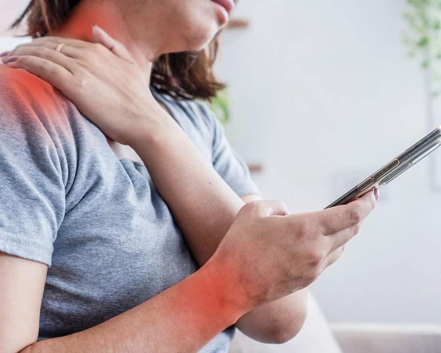 woman suffering from neck and shoulder pain after using mobile phone too long with poor posture, showing effects of smartphone overuse, digital strain