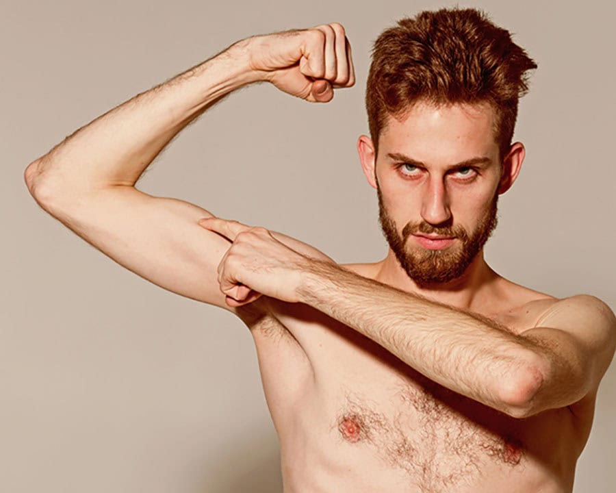 Skinny young man flex arm. Stimulating muscle growth increases muscle strength 