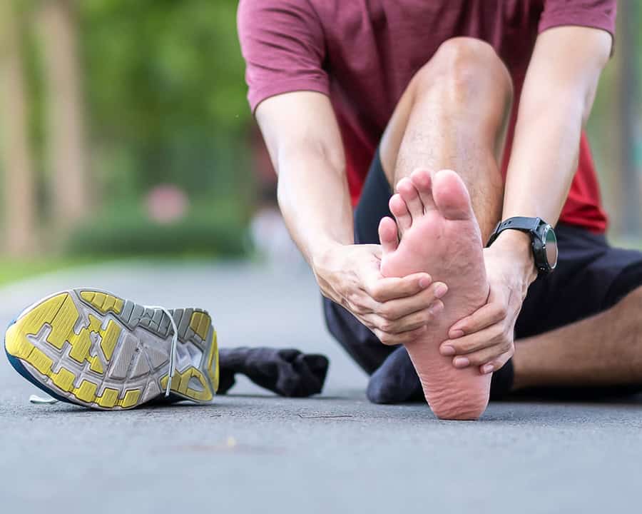 Young adult male with his muscle pain during running, having leg ache due to Plantar fasciitis.
