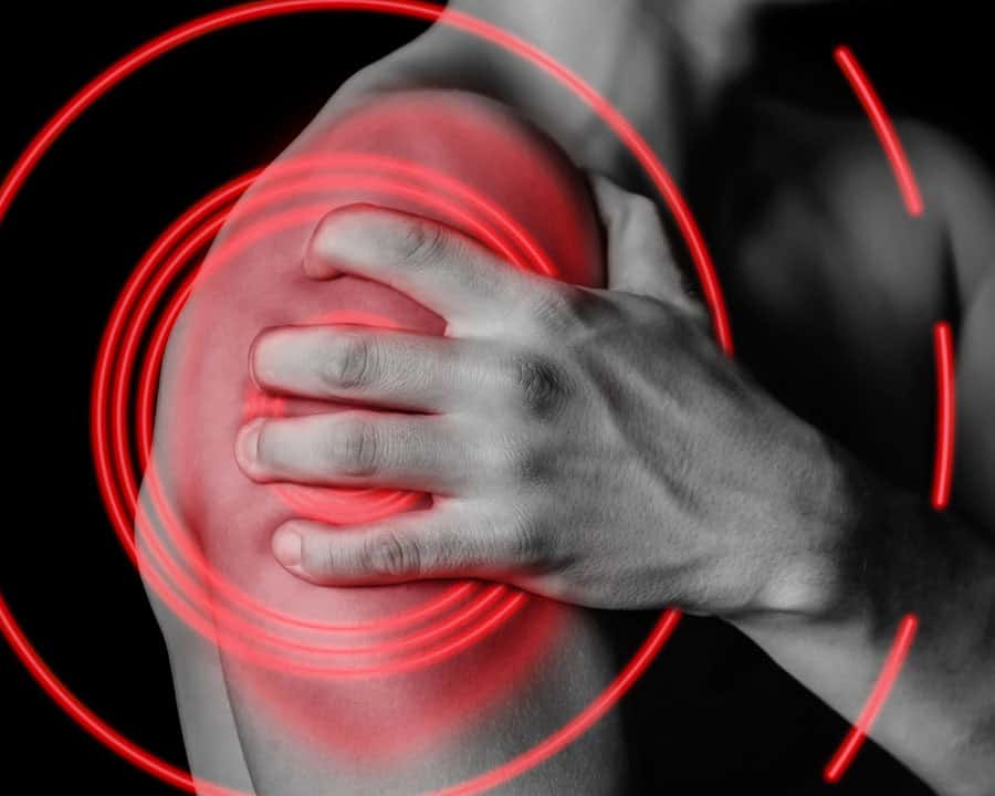 Man with shoulder pain, inflamed area highlighted in red